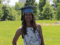 Female student nurse in park with graduation cap.